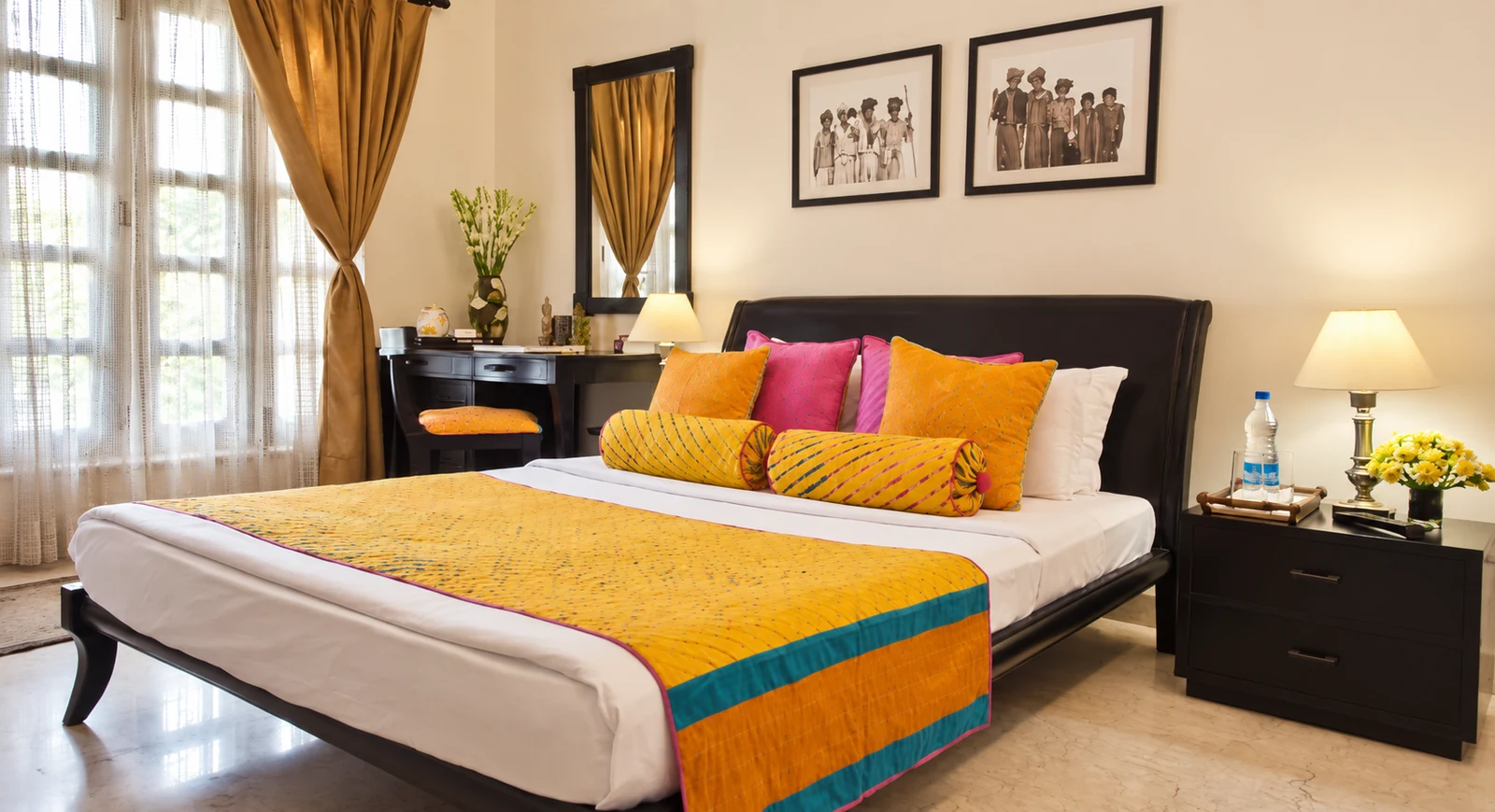 Bedroom at Colonel’s Retreat, Delhi, with colourful cushions and a large window